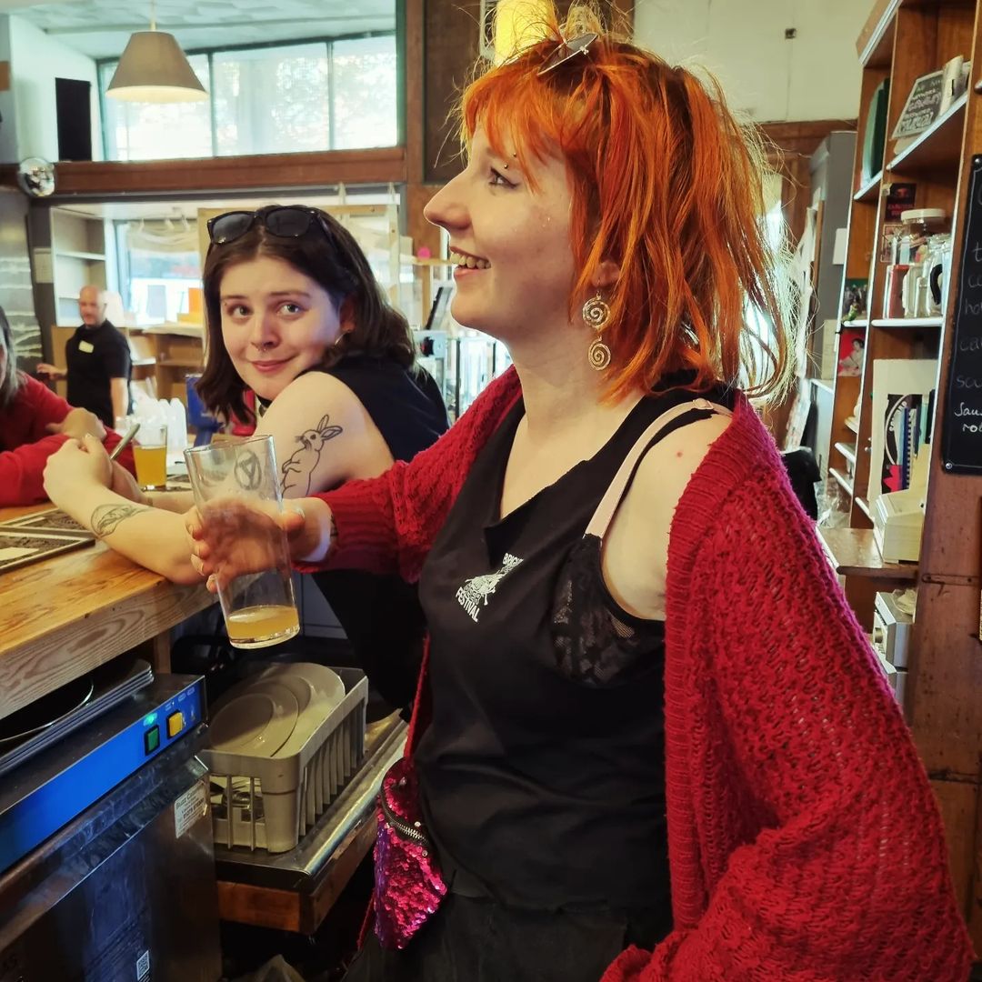 people smiling and drinking at a bar